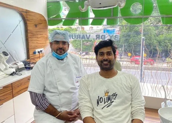 Dr. Varun seated beside a smiling patient