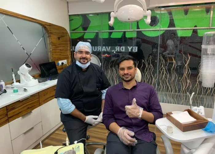 Dr. Varun with a patient giving a thumbs up